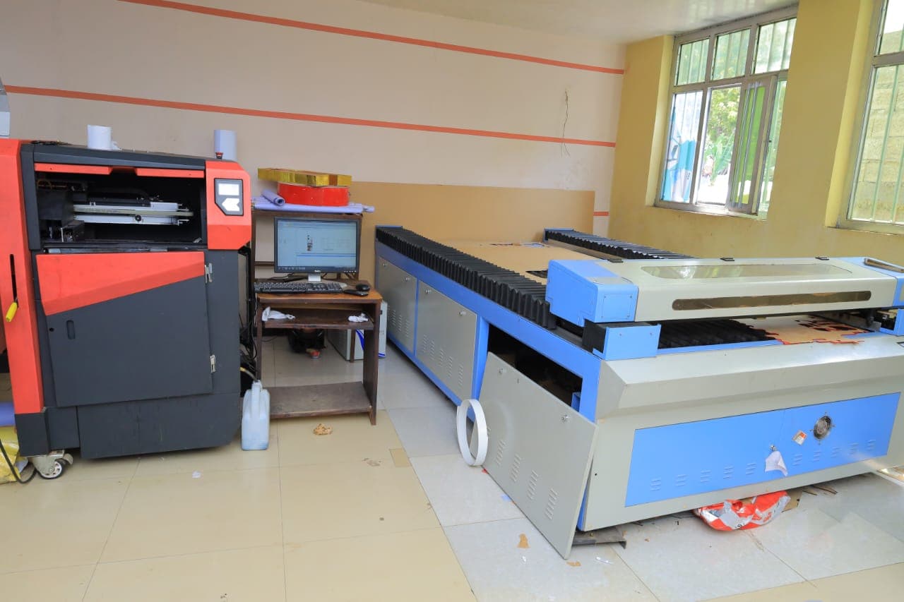 UV printer and CNC laser cutter on our production floor